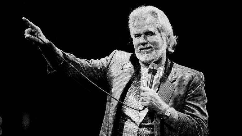 Kenny Rogers pointing while holding microphone