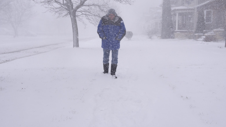man walking in blizzard