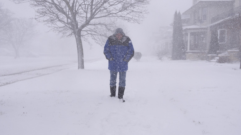 man walking in blizzard
