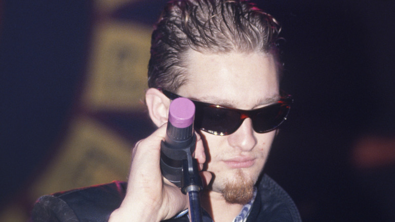 Layne Staley holding microphone and looking down