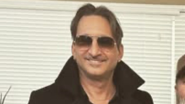 Johnny Bacolas smiling in sunglasses