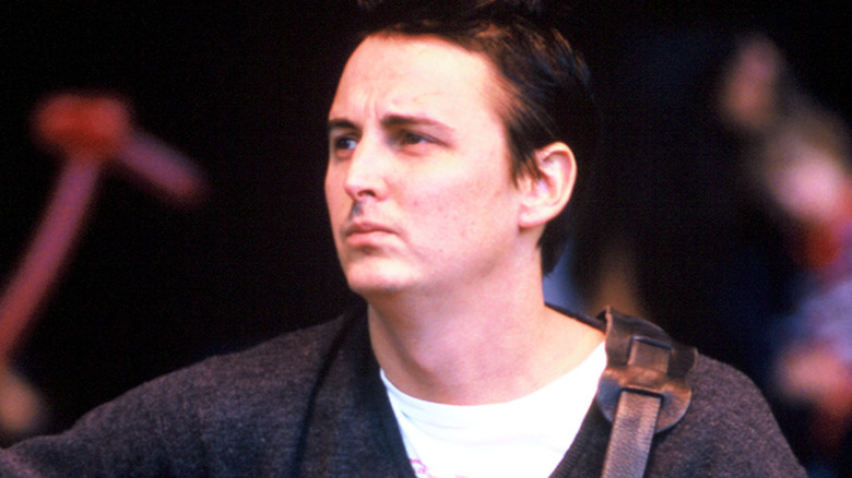 Mike McCready playing guitar and looking off
