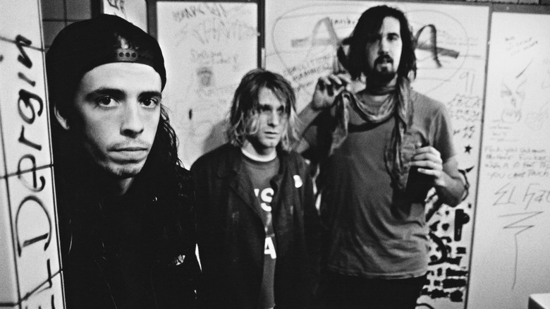 Nirvana hanging out in a graffiti-filled bathroom