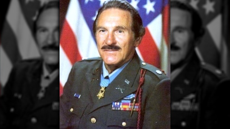 Matt Urban smiling in uniform with U.S. flag