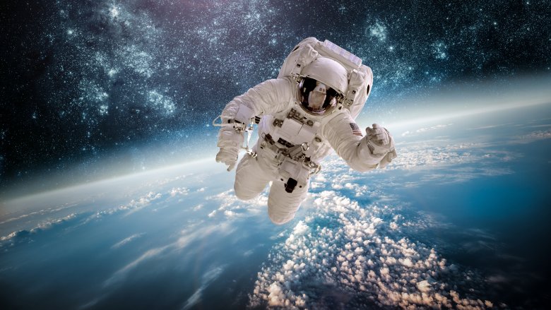 astronaut floating above Earth