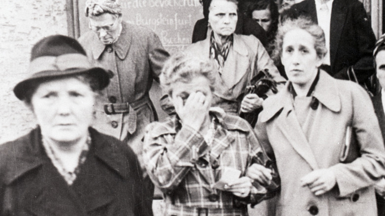 women weeping after having seen images of nazi atrocities