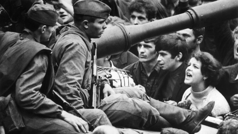 protestors shout at soviet soldier in prague 1968