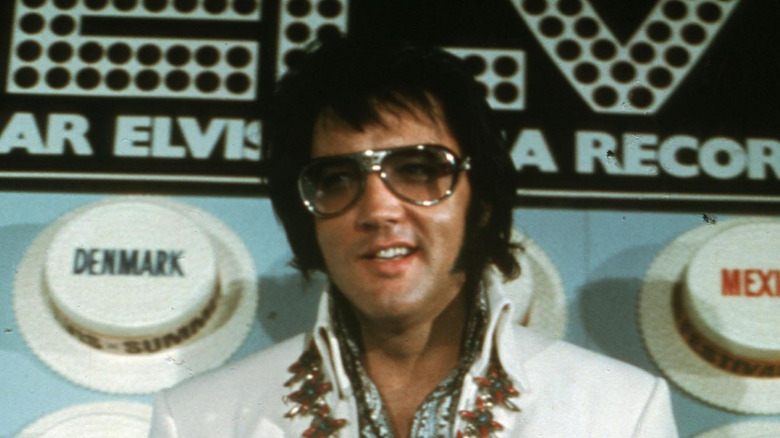 Elvis Presley in big glasses and jumpsuit