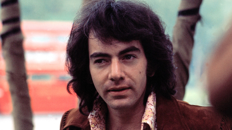 Neil Diamond squinting in suede jacket