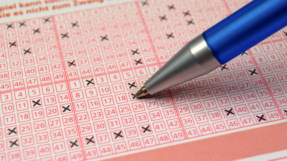 Pen filling out lottery ticket