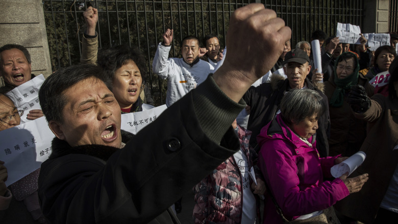 Chinese protestors outside embassy fists raised