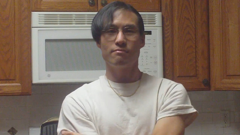 Alex Chiu posing front of his microwave
