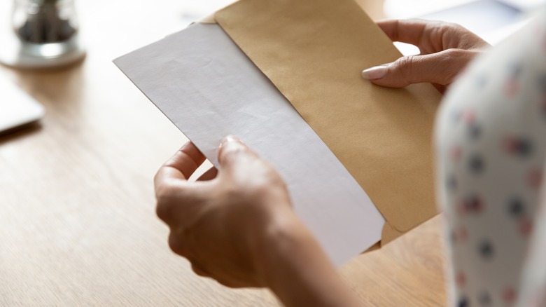 woman opening letter