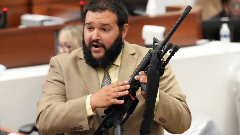 Sheriff holds AR-15 rifle