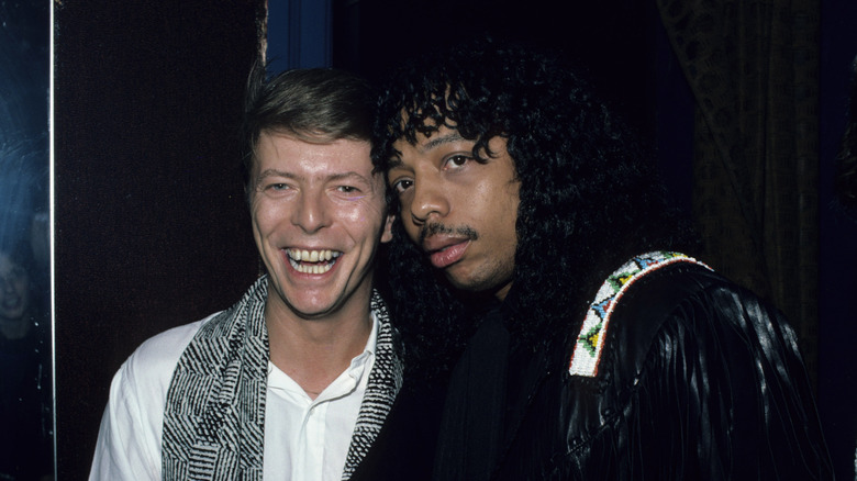 David Bowie and Rick James posing backstage