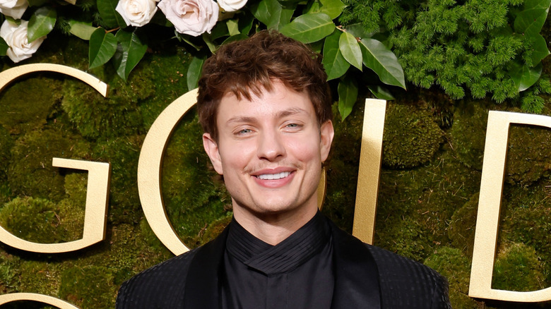 Matt Rife in dark suit smiling