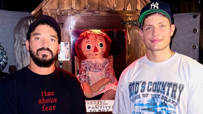 Matt Rife posing with the Annabelle doll