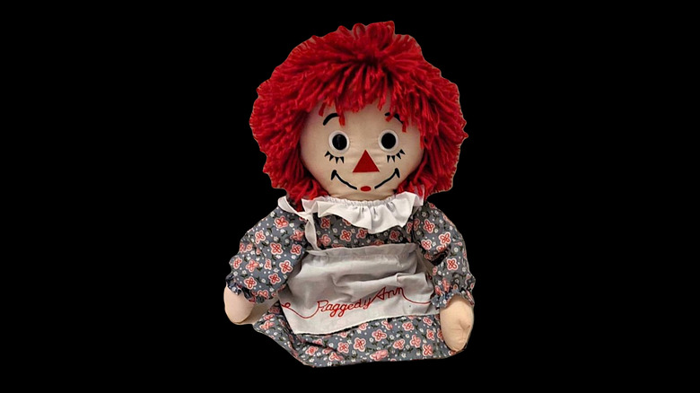 Raggedy Ann doll on black background