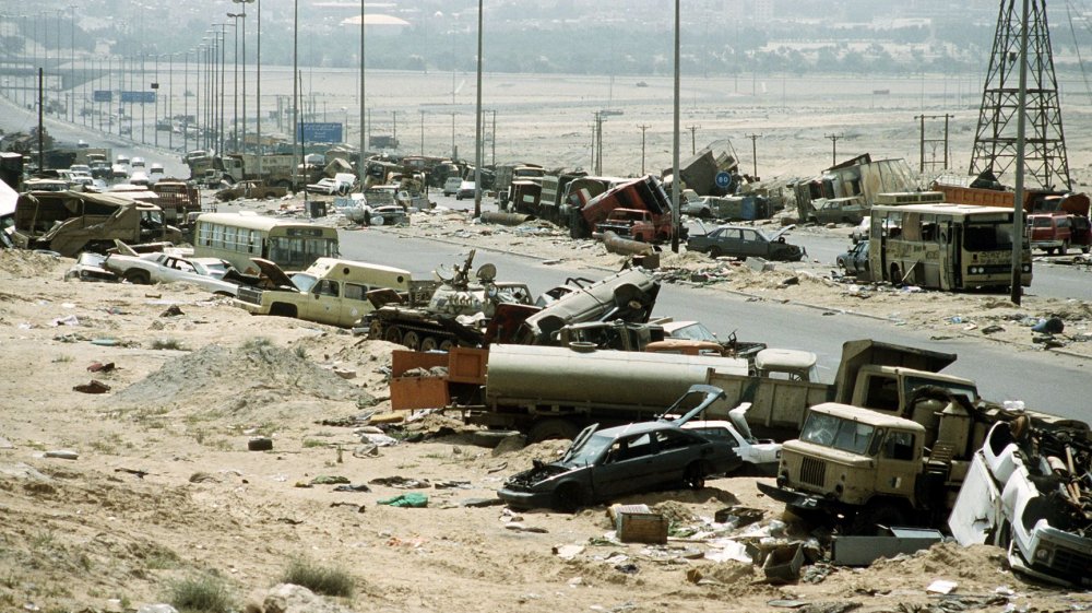 Demolished vehicles line Highway 80