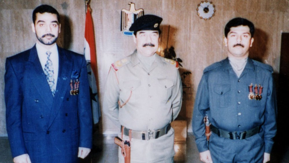 Iraqi President Saddam Hussein poses with his sons Uday and Qusay in an undated photo