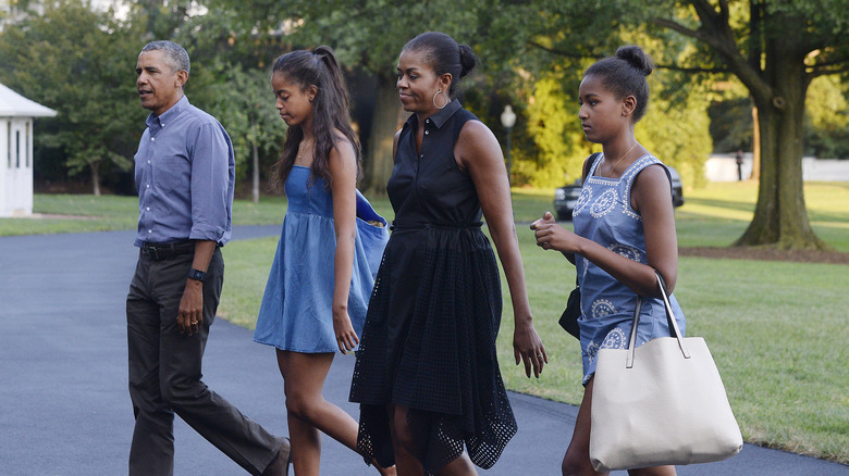 Obama parents walking with daughters