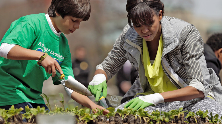Michelle Obama planting gardens with students