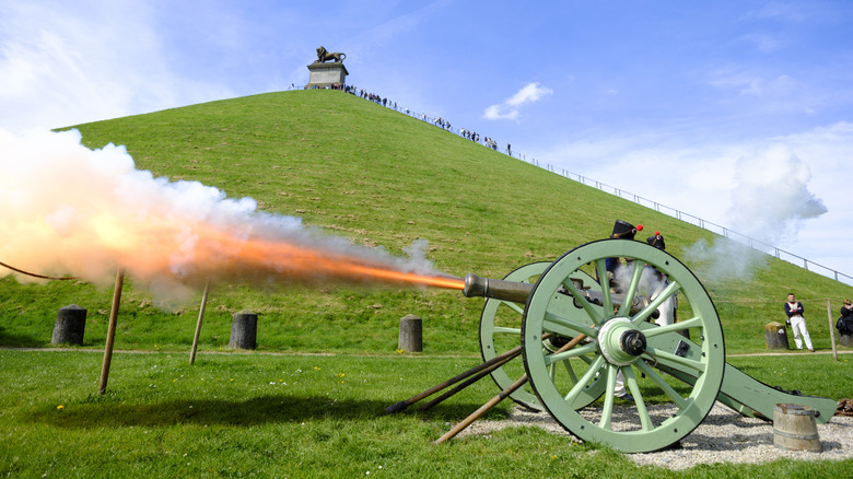 Napoleonic era cannon firing by large hill