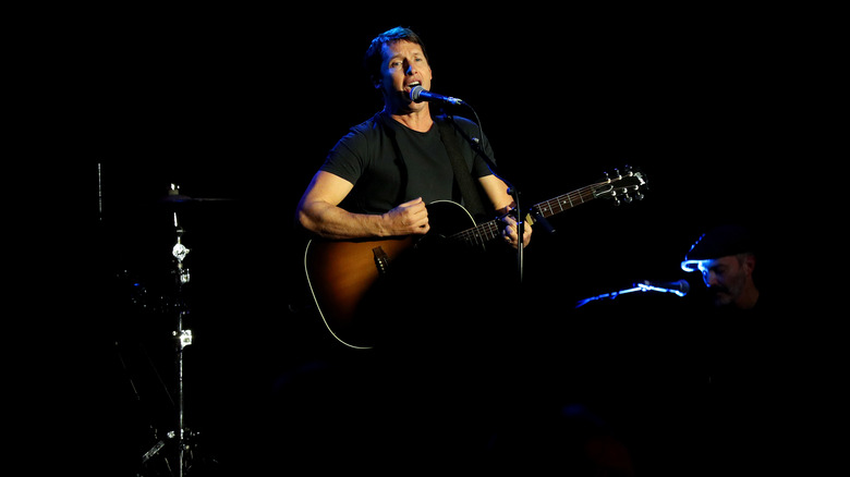 James Blunt playing guitar and singing on stage