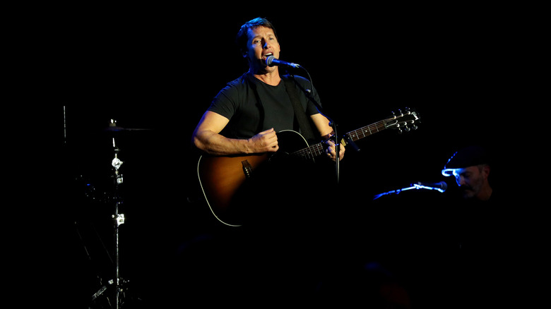 James Blunt playing guitar and singing on stage