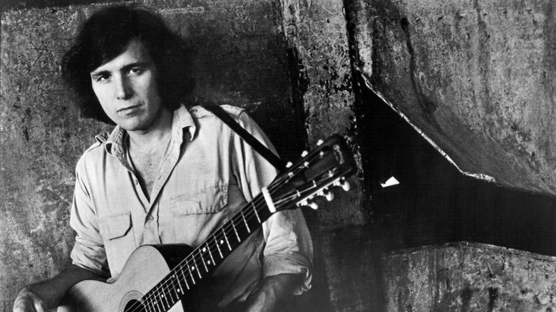 Don McLean with acoustic guitar staring ahead