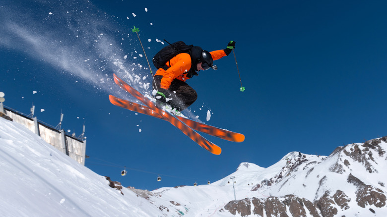 Skier jumping down a slope