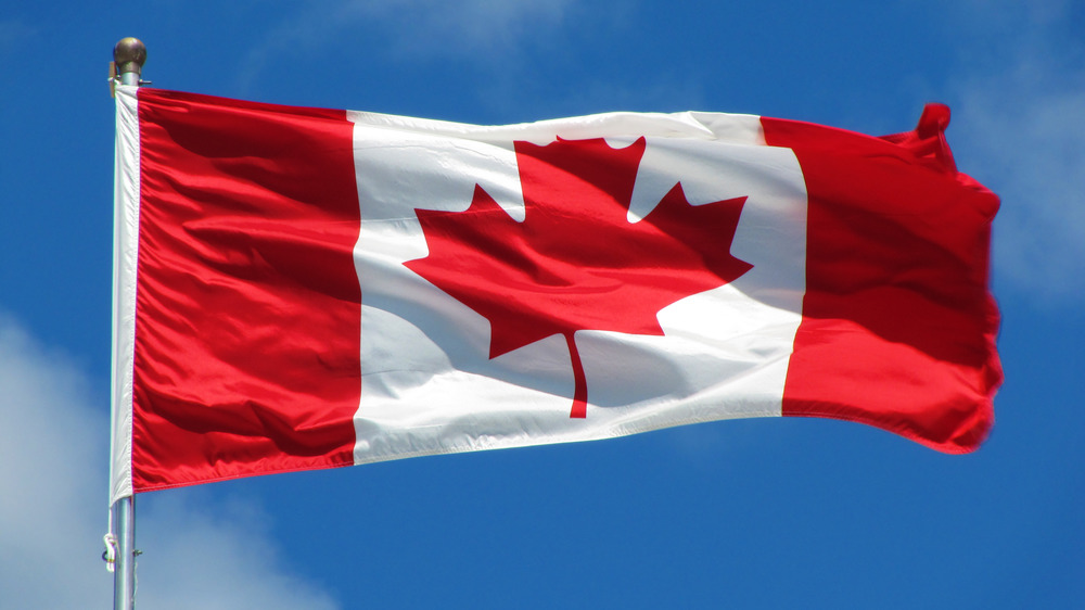 Canadian flag against blue sky