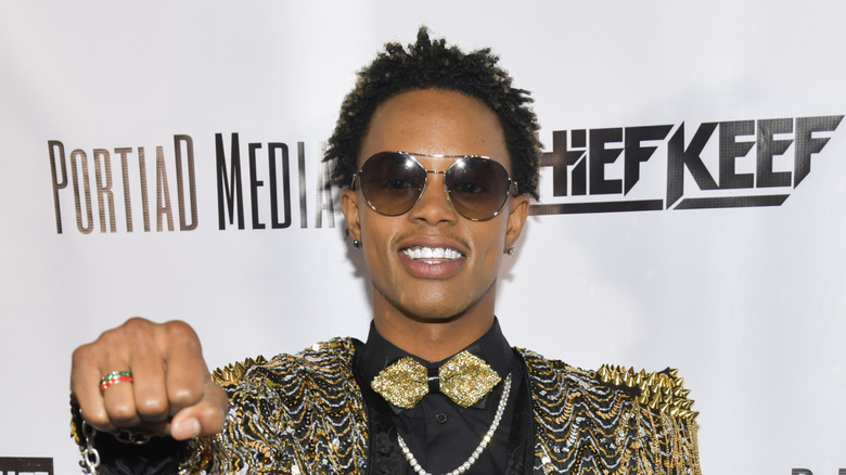 Silento smiling and holding out fist in sunglasses