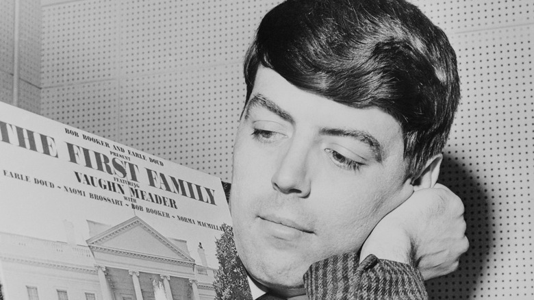 Vaughn Meader looking at First Family album