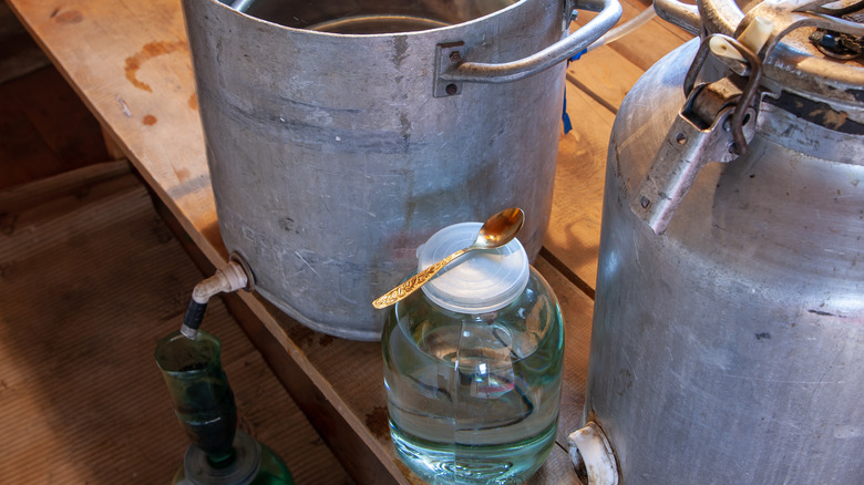 jar of moonshine and distilling equipment