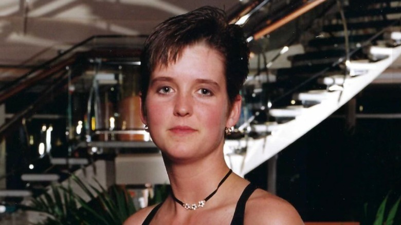 Amy Bradley with short hair and earings smiling