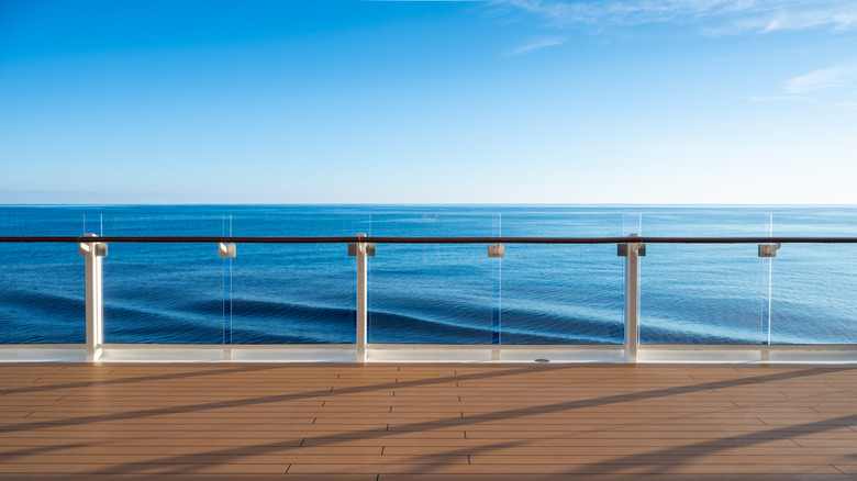 The railing of a cruise ship on a deck that overlooks the ocean