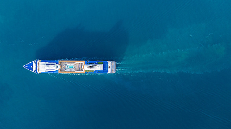 An aerial view of a cruise ship sailing in blue water.
