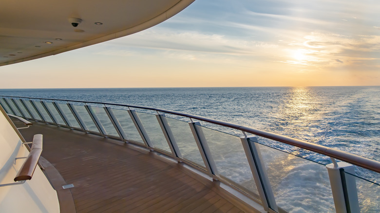 The view of a side deck on a cruise ship looking out at the ocean