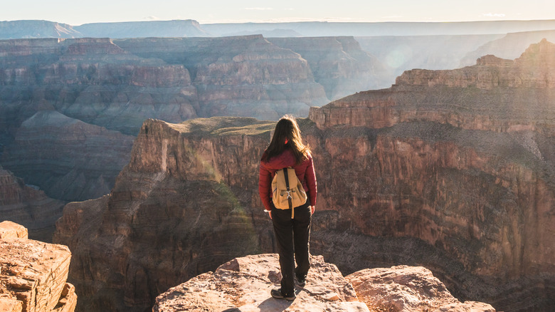 Hiker standing on the edge of the Grand Canyon