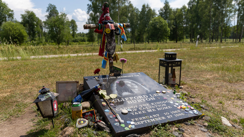The gravesite of Metallica bassist Cliff Burton covered in guitar picks and other trinkets