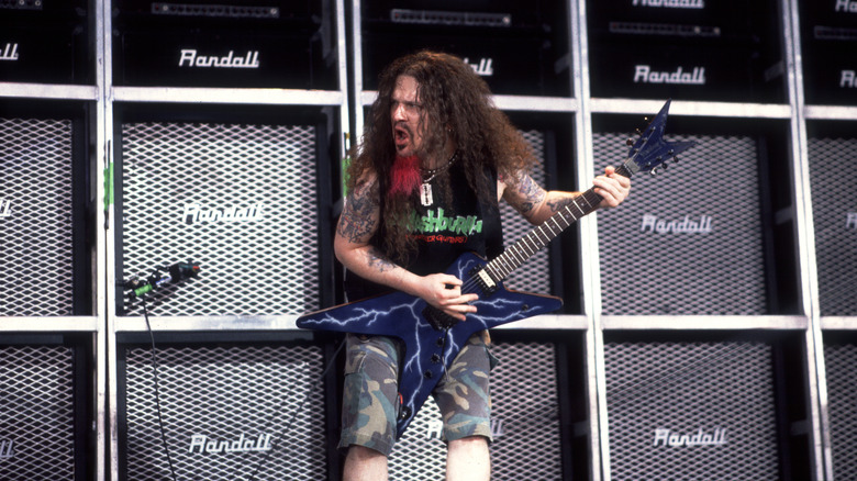 Dimebag Darrell shredding in front of a wall of amps