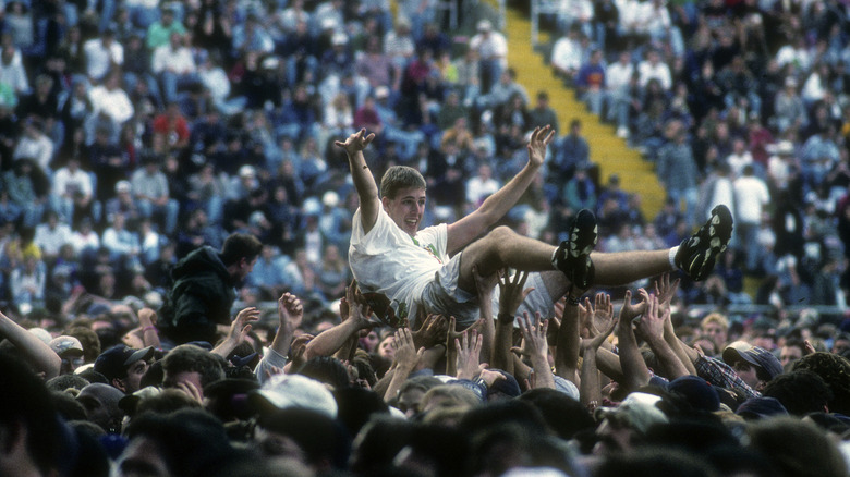 A fan crowd surfing at a 1996 Pearl Jam concert in New York City