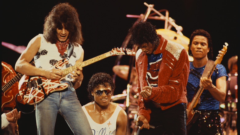 Eddie Van Halen plays guitar on stage with Michael Jackson