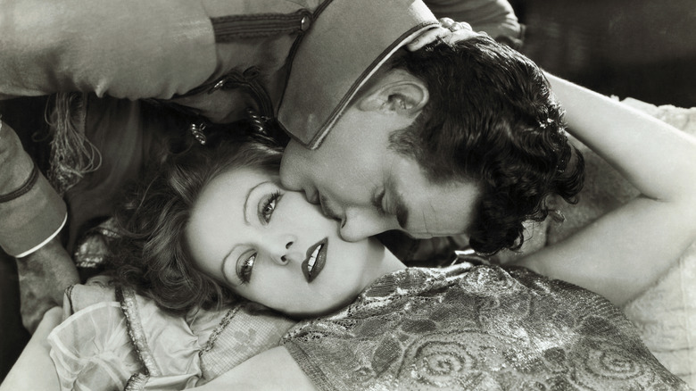 greta garbo tolerating a kiss from a man incharacter as queen christina