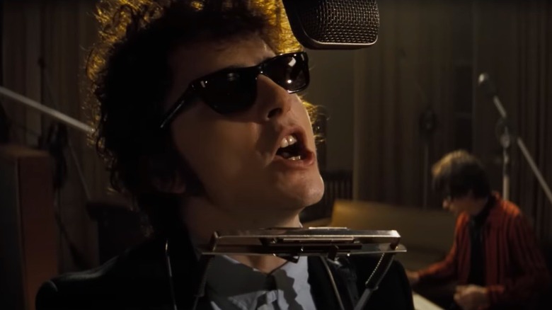 Timothee Chalamet as Bob Dylan in the recording studio in a scene from A Complete Unknown