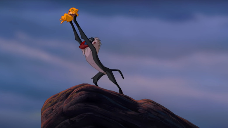 Rafiki holding Simba