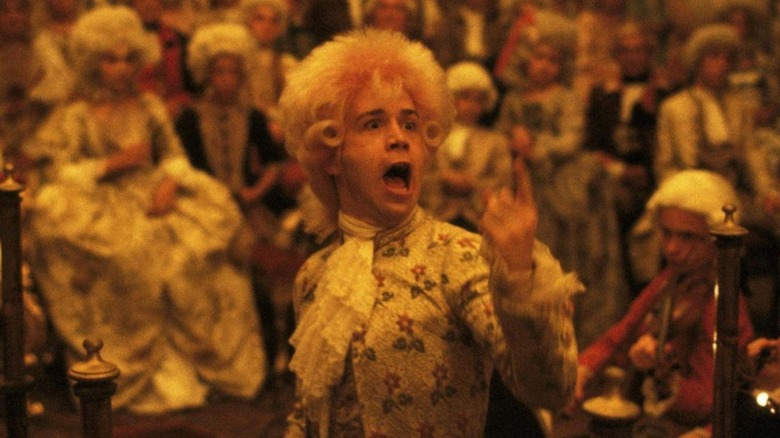 Mozart performing a concert with finger raised in a still from Amadeus