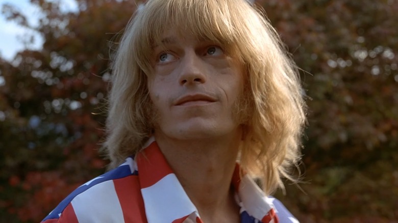 Brian Jones outdoors looking up in a still from Stoned