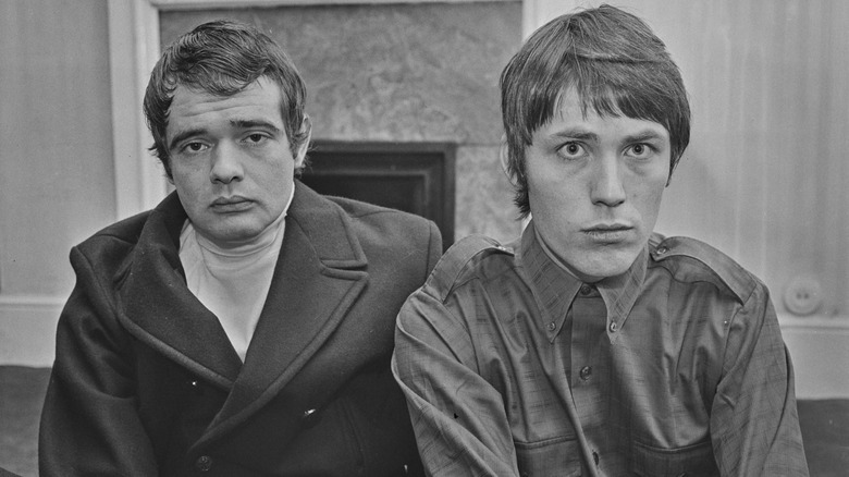 Kit Lambert and Chris Stamp sat indoors looking glum